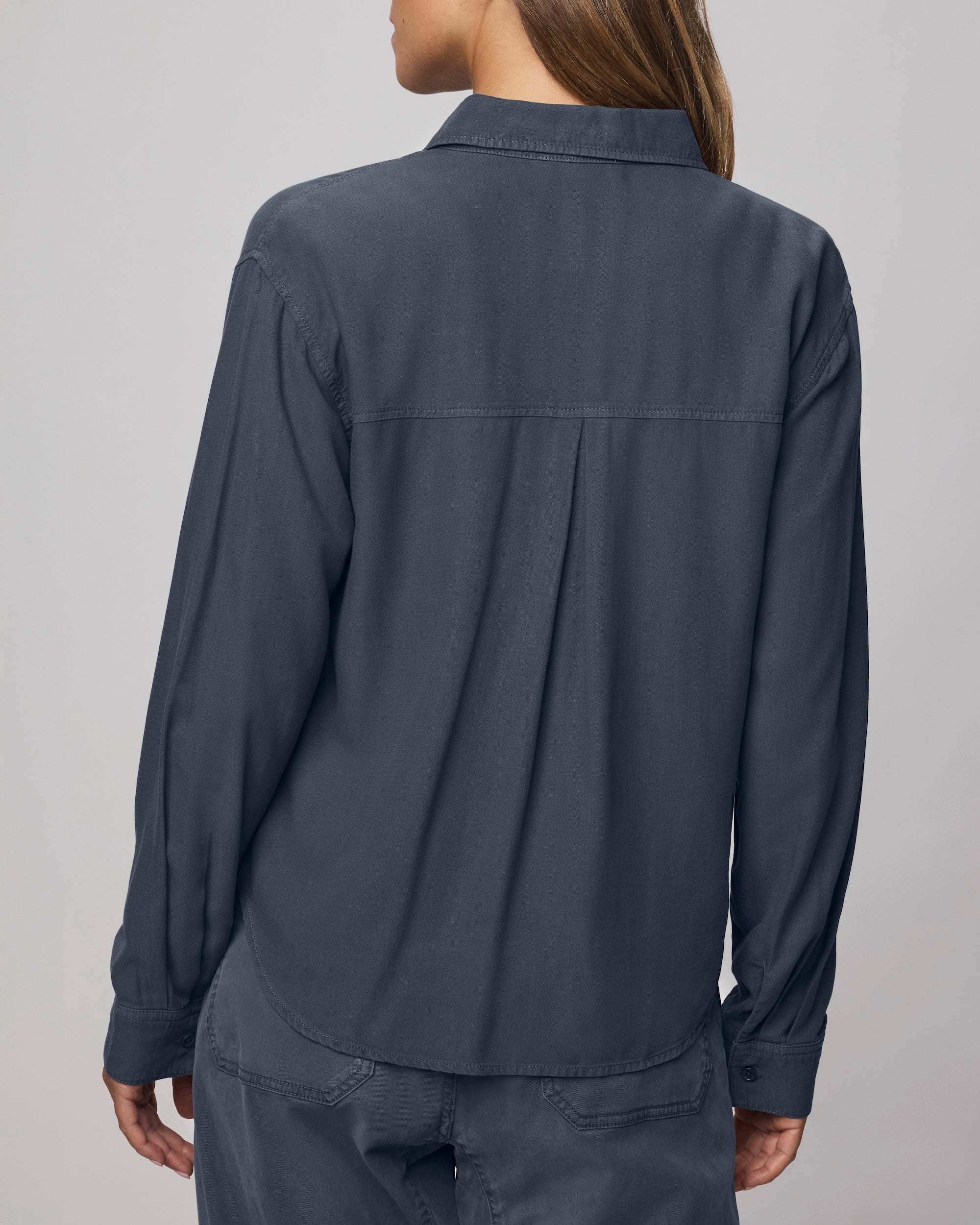 A person with long hair is seen from the back wearing the Splendid Joanne Blouse in dark blue and matching pants, set against a plain light gray background.