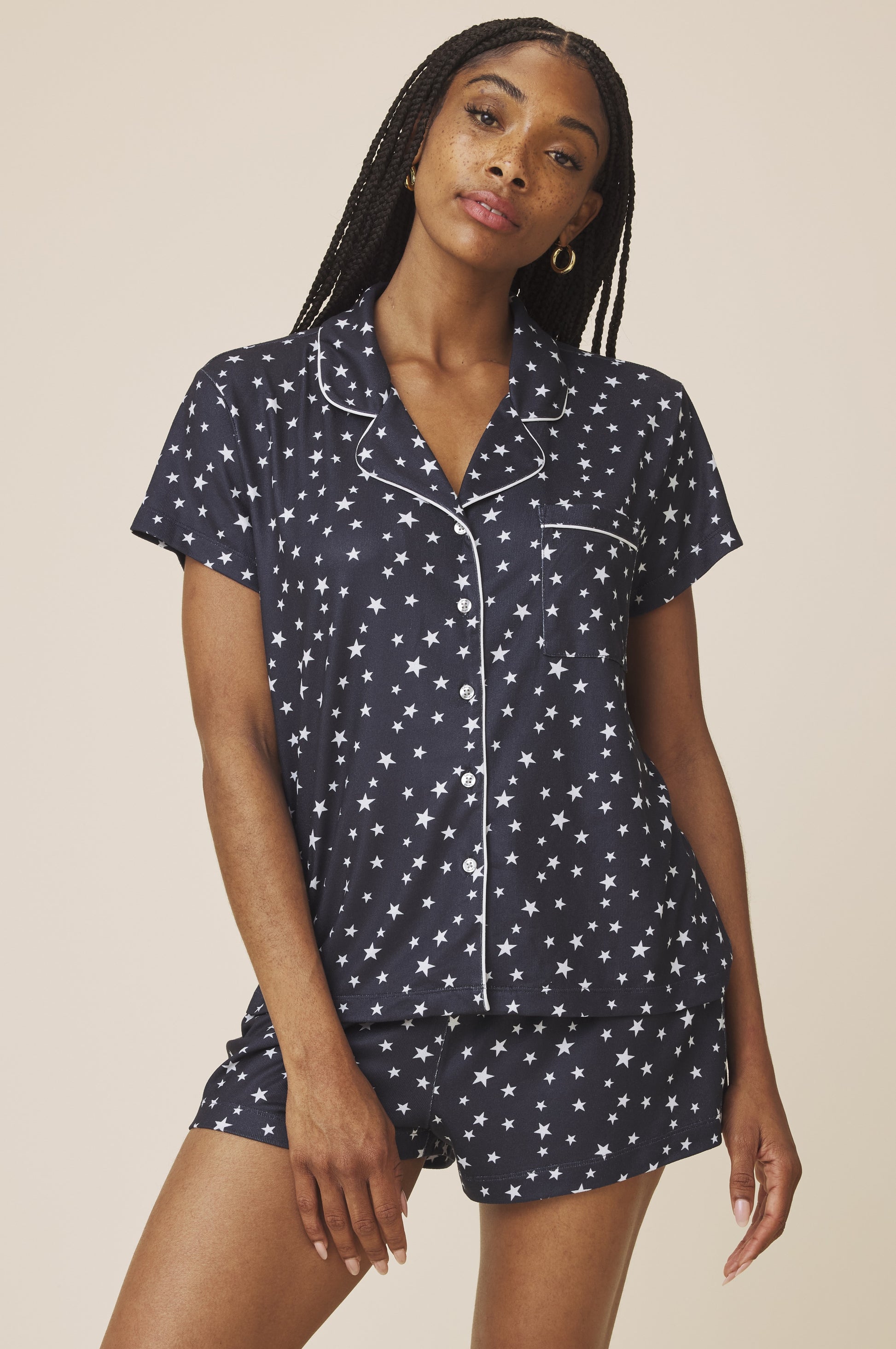 A woman models the Splendid Flora Pillow Soft PJ Short Set in Navy Multi, featuring a matching star pattern—an ideal pick for comfortable, lightweight sleepwear.