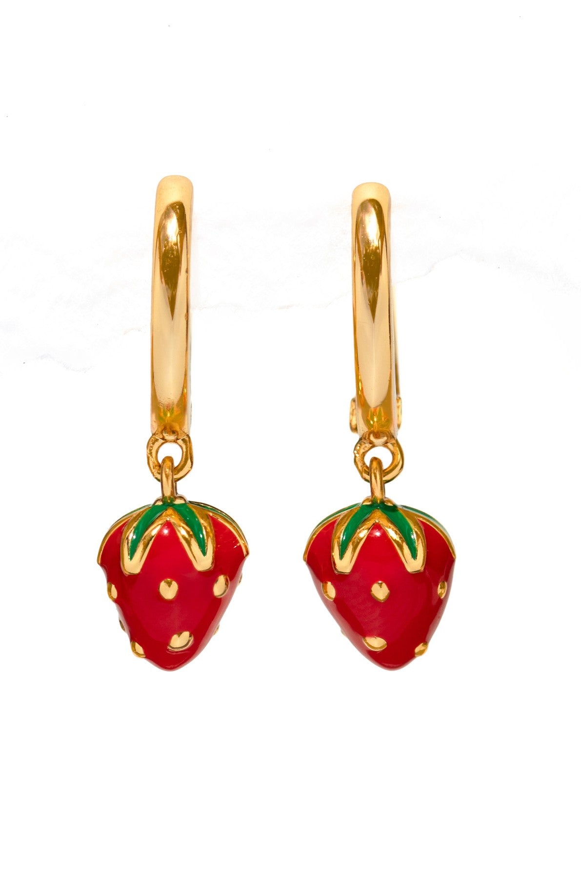 The Girls Crew Enamel Strawberry Mini Hoops feature gold hoops with dangling red strawberry charms, green leaves, and yellow dots, offering a playful fruit-inspired look against a plain white background.