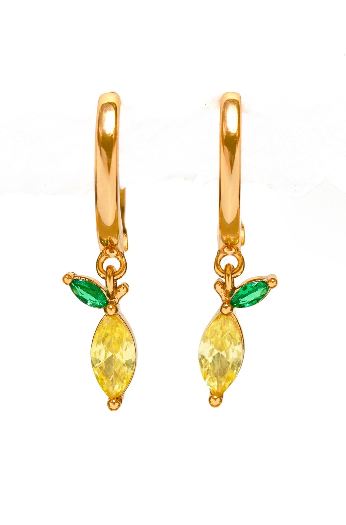 The Stone Lemon Mini Hoops by Girls Crew feature gold hoops with dangling yellow marquise stones and green accents, evoking playful lemon and leaf motifs against a white backdrop.