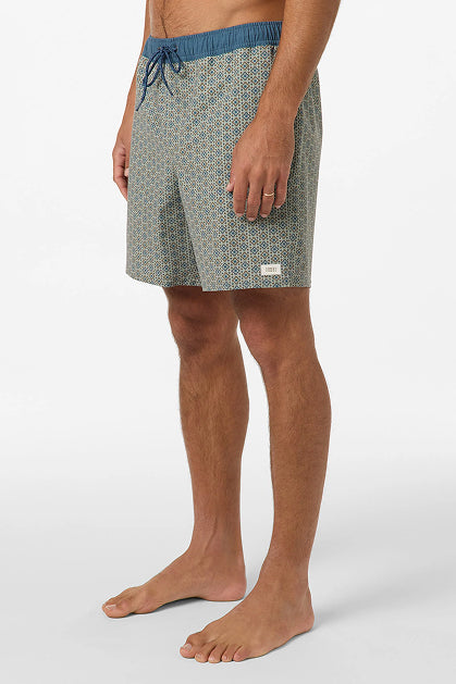A man stands barefoot wearing O'Neill Hermosa Retro 17 In Swim Trunks featuring a blue waistband and drawstring, crafted from recycled polyester, shown from mid-torso to feet against a plain white background.