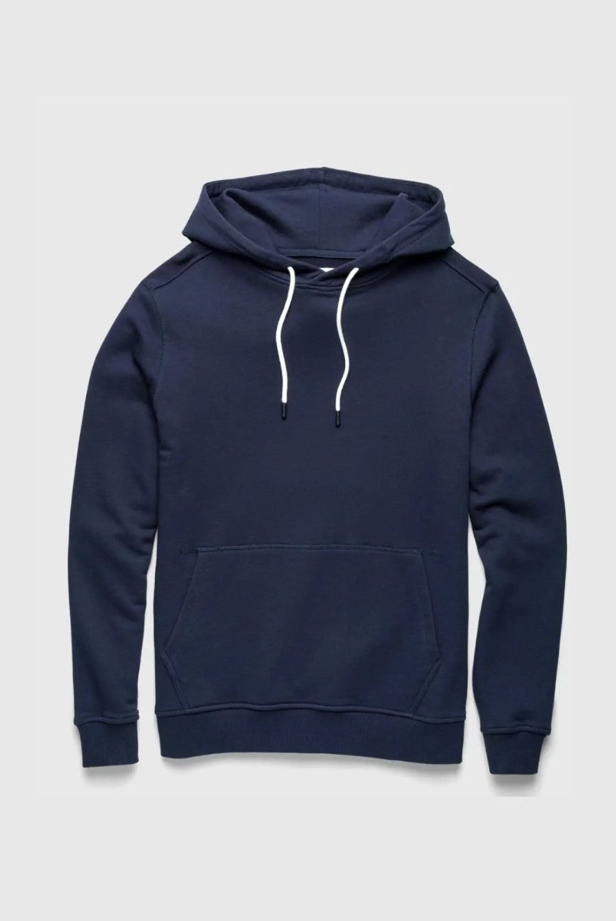 The Marine Long Sleeve French Terry Hoodie by Surfside Supply Co. is a navy sweatshirt with a drawstring hood, front pouch pocket, and white drawstrings, shown flat on a light gray background.
