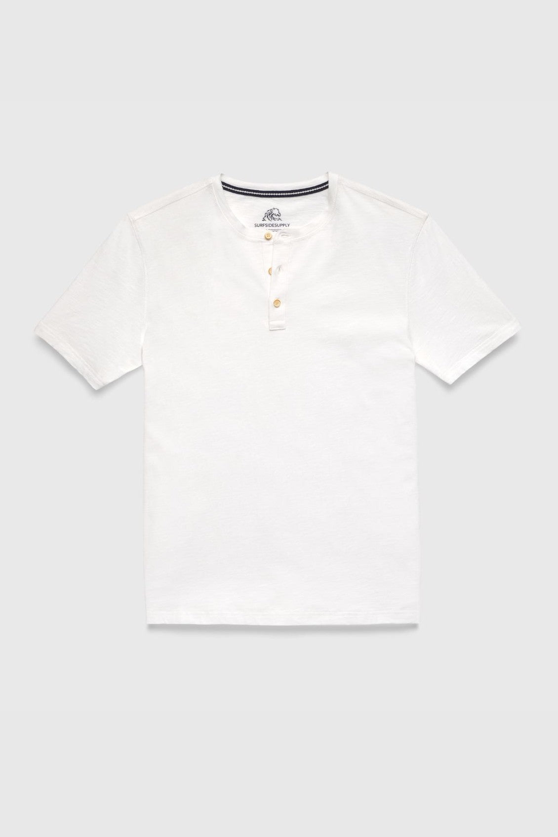 The Surfside Supply Co. Sean Short Sleeve Garment Dye Slub Henley in white features a regular fit, round neckline, three beige front buttons, and short sleeves. Displayed on a light gray background for everyday comfort.