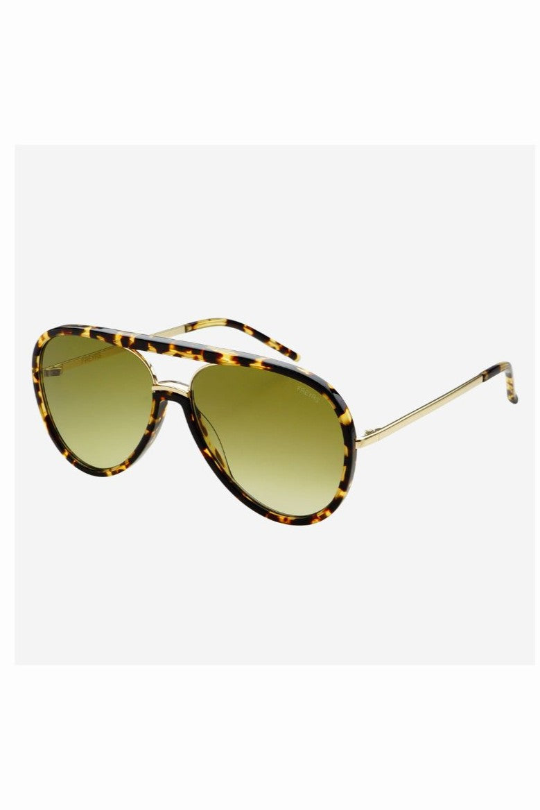 The Shay Sunnies by South Moon Under are women's aviator sunglasses with tortoiseshell frames, green-tinted lenses, and thin gold metal arms. They provide 100% UV protection and are displayed against a plain white background.