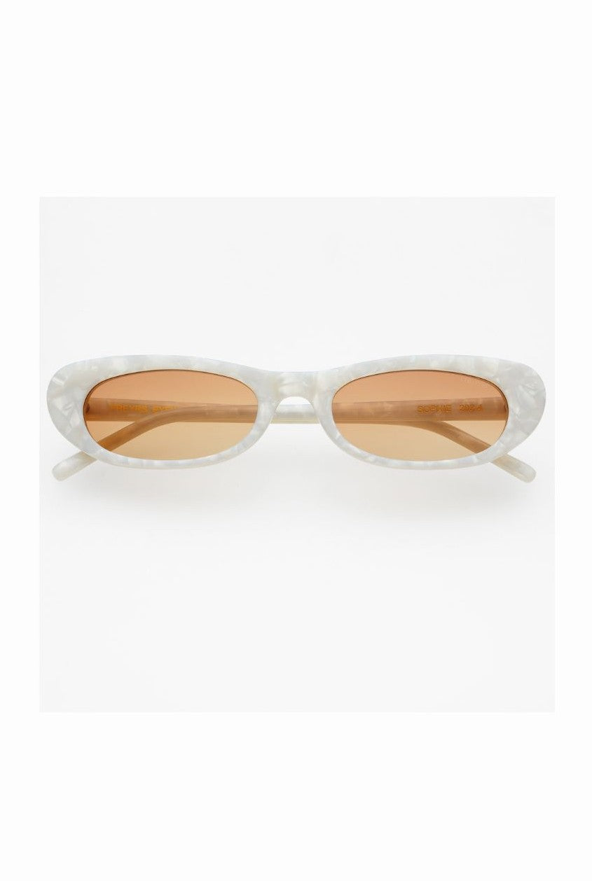 Freyrs’ Sophie Sunnies are oval-shaped designer sunglasses with white marbled frames and light brown tinted, UV-protective lenses, shown on a plain white background.