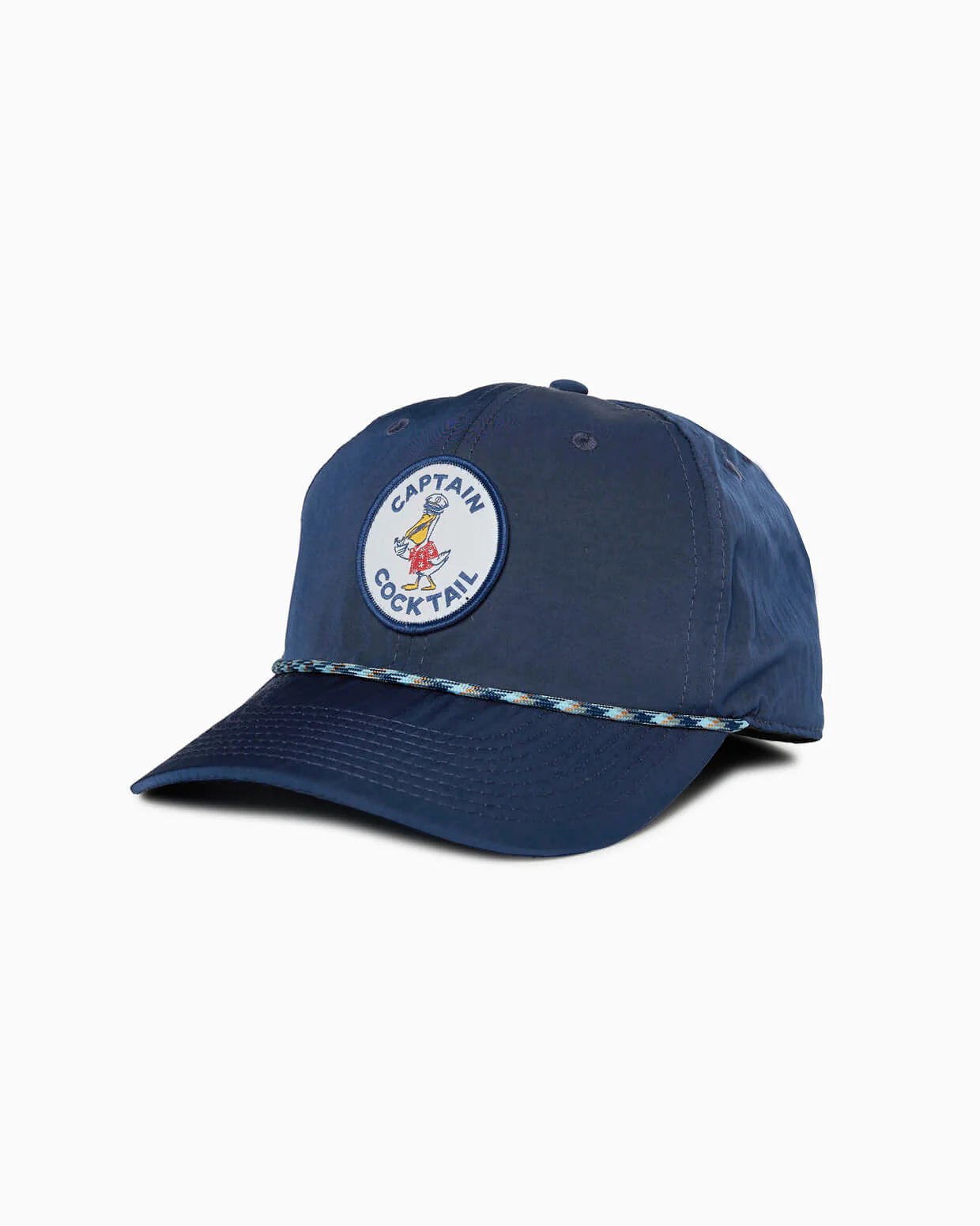 The Captain Cocktail Hat by Toes on the Nose is a navy blue, unstructured 5 panel with a cartoon bird and “Captain Cocktail” round patch, adjustable snapback, and braided rope detail across the brim.