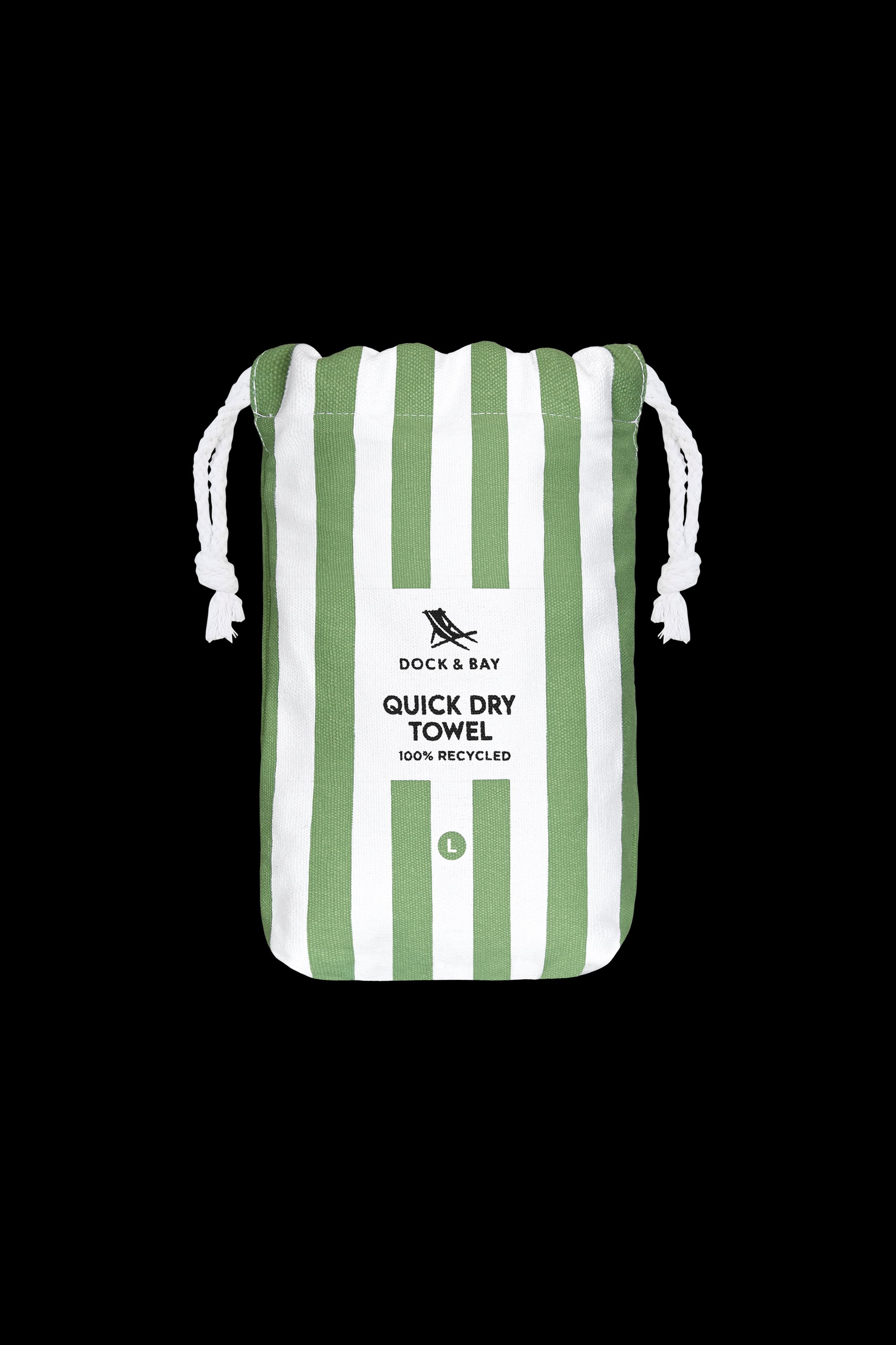 A green and white striped drawstring bag labeled South Moon Under Cayman Olive Stripe Towel, with a small L at the bottom, features a lightweight quick-dry microfiber travel beach towel, shown on a black background.