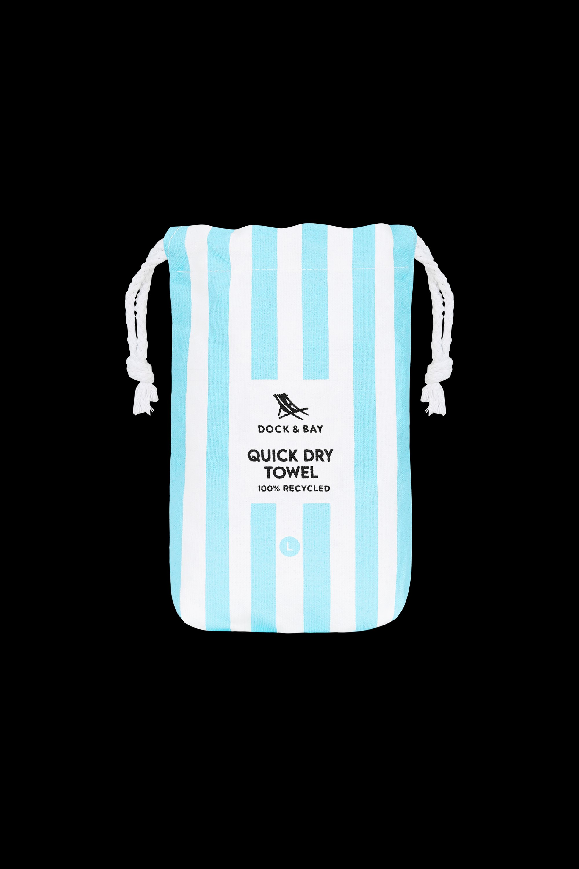 A white drawstring bag with vertical light blue stripes and "South Moon Under Tulum Blue Large Stripe Towel" text, featuring quick-dry microfibre, is photographed against a black background.