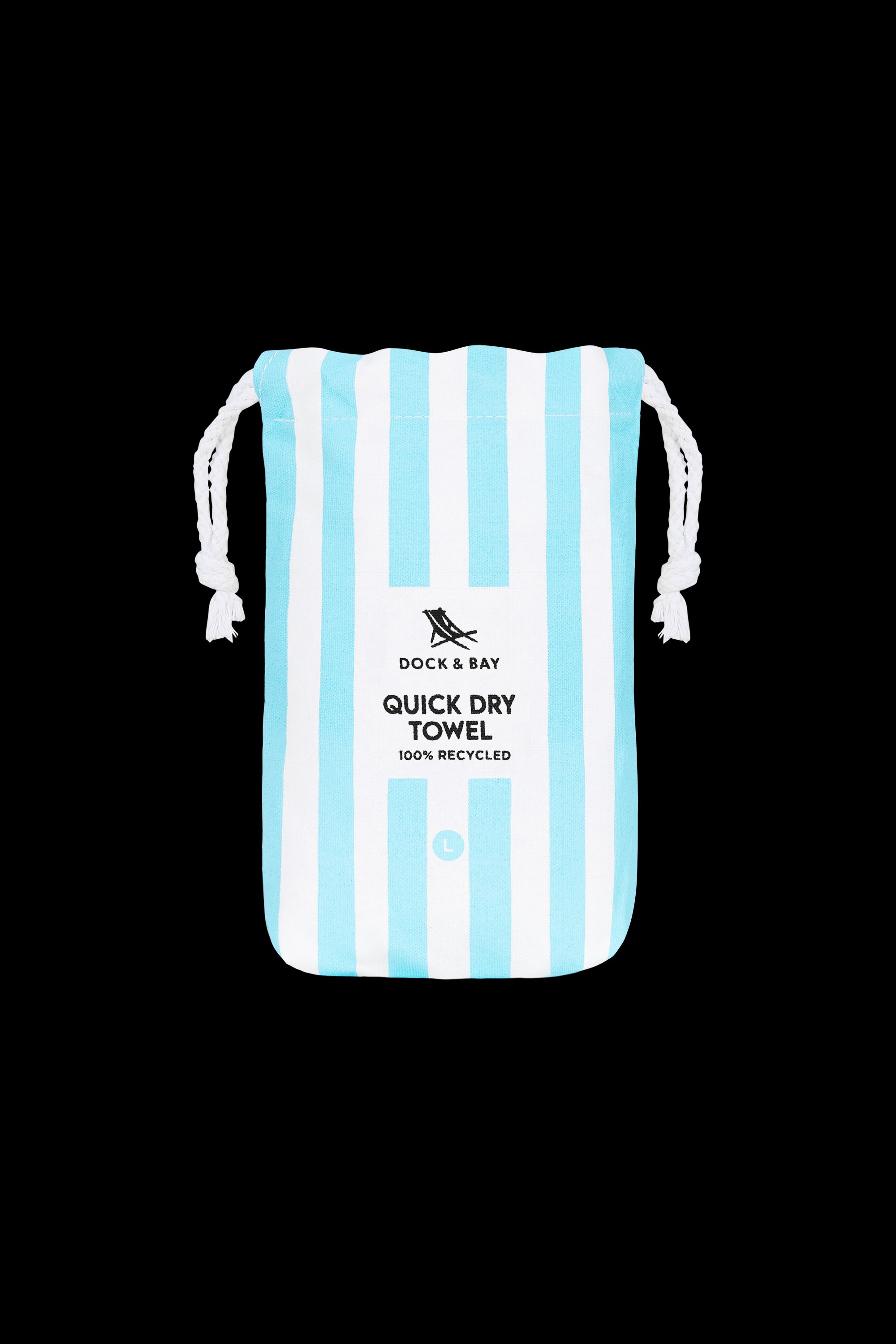 A white drawstring bag with vertical light blue stripes and "South Moon Under Tulum Blue Large Stripe Towel" text, featuring quick-dry microfibre, is photographed against a black background.