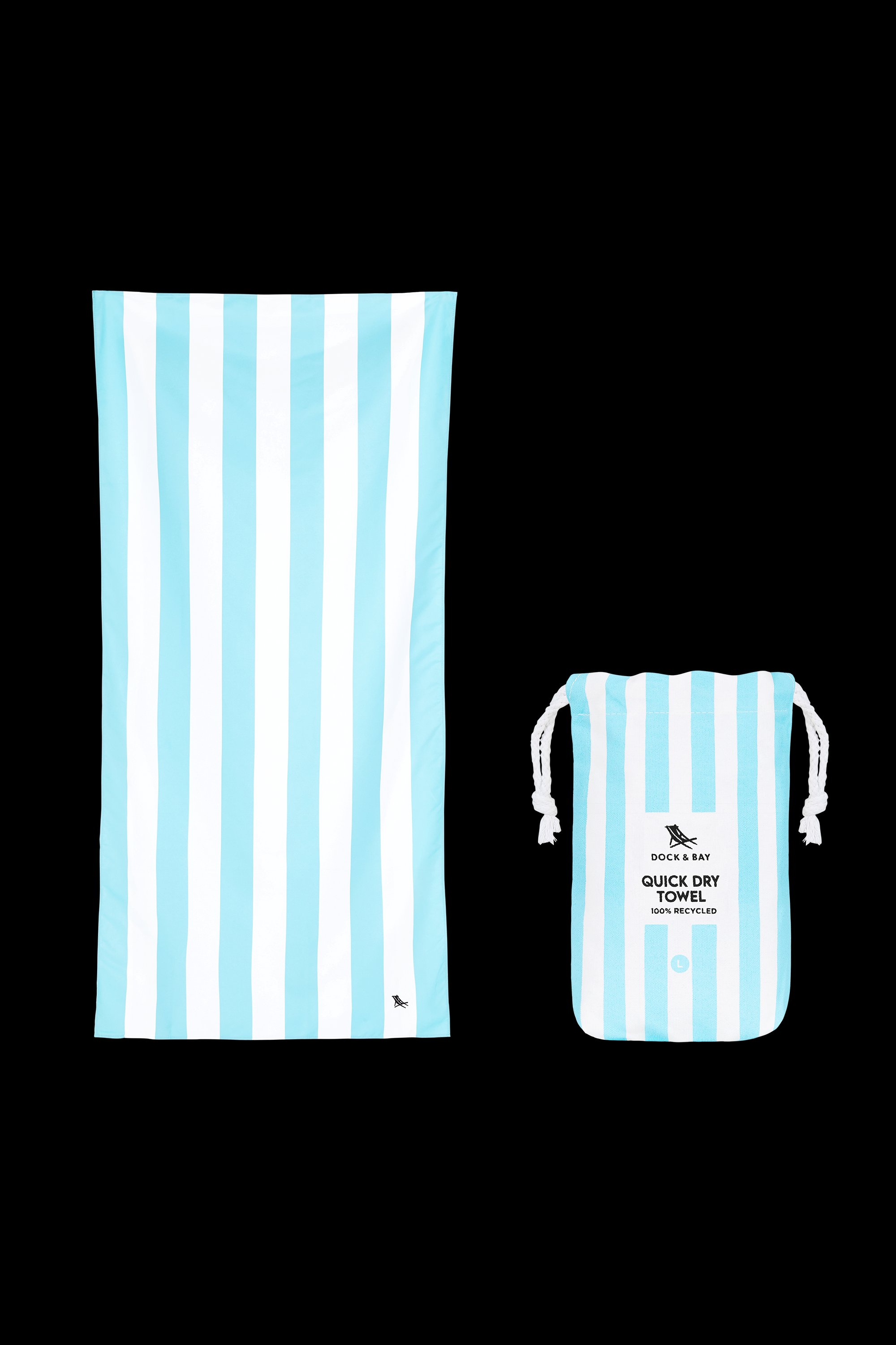 The South Moon Under Tulum Blue Large Stripe Towel, in light blue and white quick-dry microfiber, is shown beside its matching lightweight drawstring pouch against a black background.