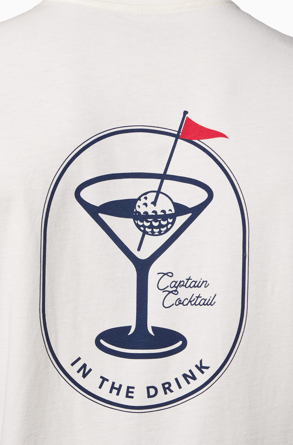 The In The Drink Short Sleeve Tee by Toes on the Nose features a martini glass with a golf ball, cocktail pick with red flag, and "IN THE DRINK" curved below—crafted from soft Peruvian Cotton.