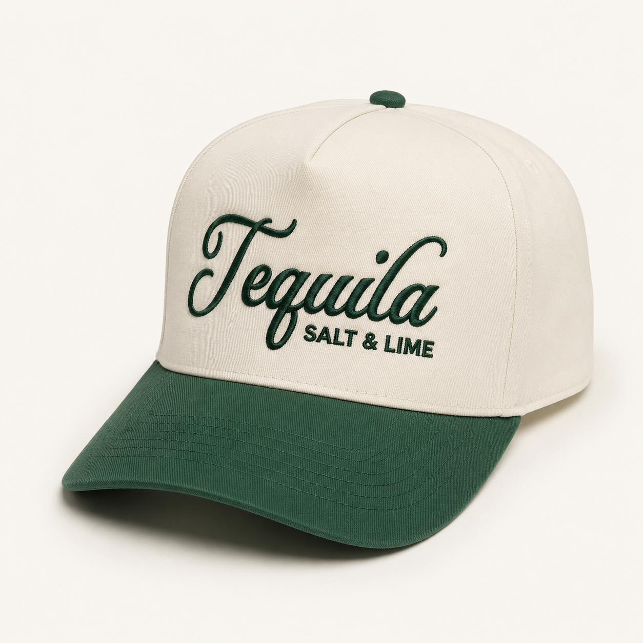 The South Moon Under Tequila Salt And Lime 5-Panel Hat features a cream color with a dark green brim and button, "Tequila" script and green "SALT & LIME" embroidery—ideal as a fun beach or relaxed trucker hat for sunny days.