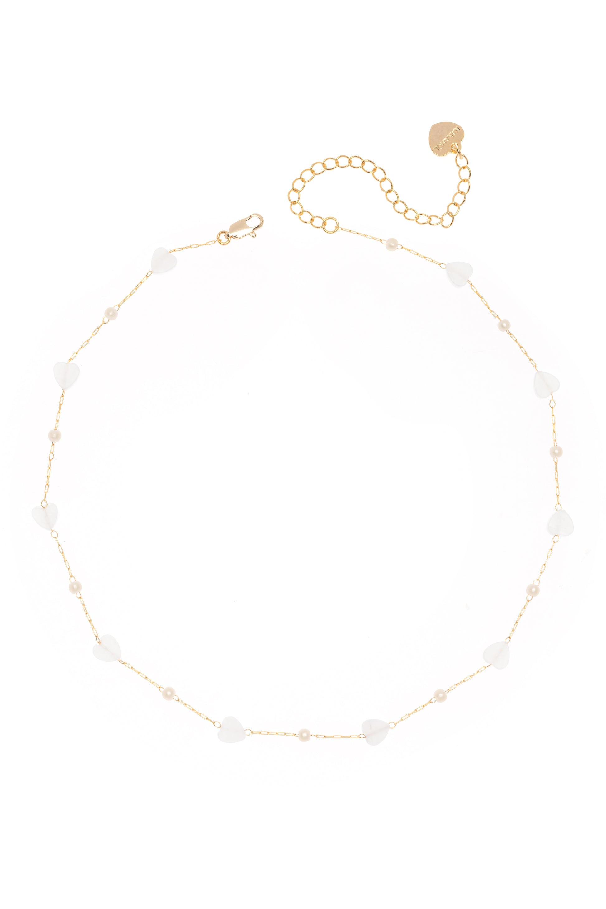 The Dainty Pearl Necklace by South Moon Under features a gold chain with small white heart charms, round beads, pearl accents, an adjustable clasp, and a short extension chain finished with a flat gold disc.