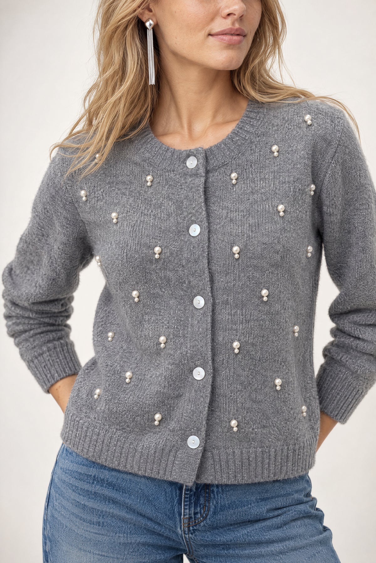 Gray ribbed cardigan with scattered pearl and white button embellishments throughout the front.