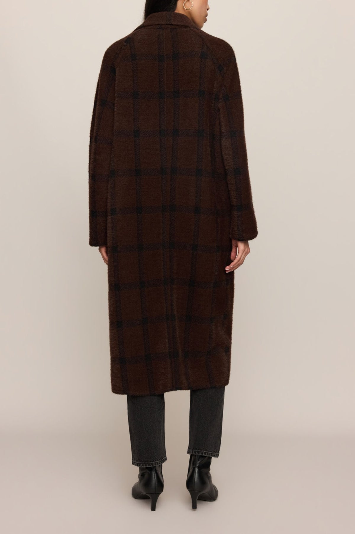 Brown plaid cocoon coat with spread collar, worn over denim and black boots, shown from back view.