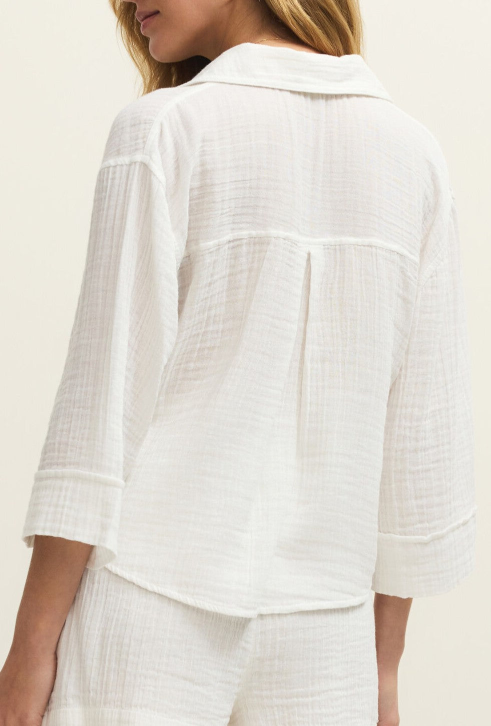 A person is shown from the back, wearing the Z Supply Helena Gauze Shirt—a loose, textured cotton top with a collar—paired with matching shorts against a plain light background.