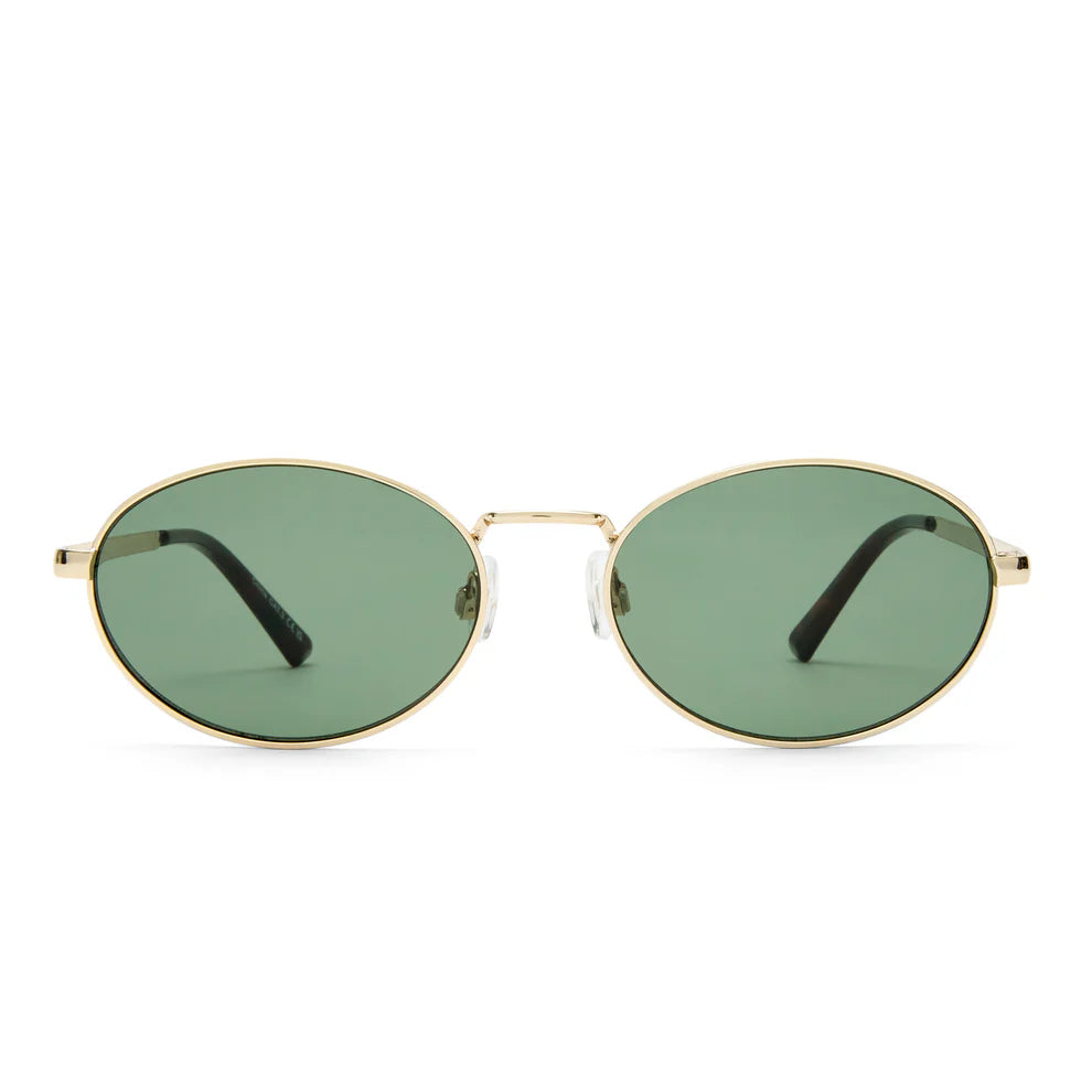 The Aire Ephermeris Sunnies feature oval-shaped gold recycled metal frames, green scratch-resistant lenses, and black ear pieces, shown facing forward against a plain background.