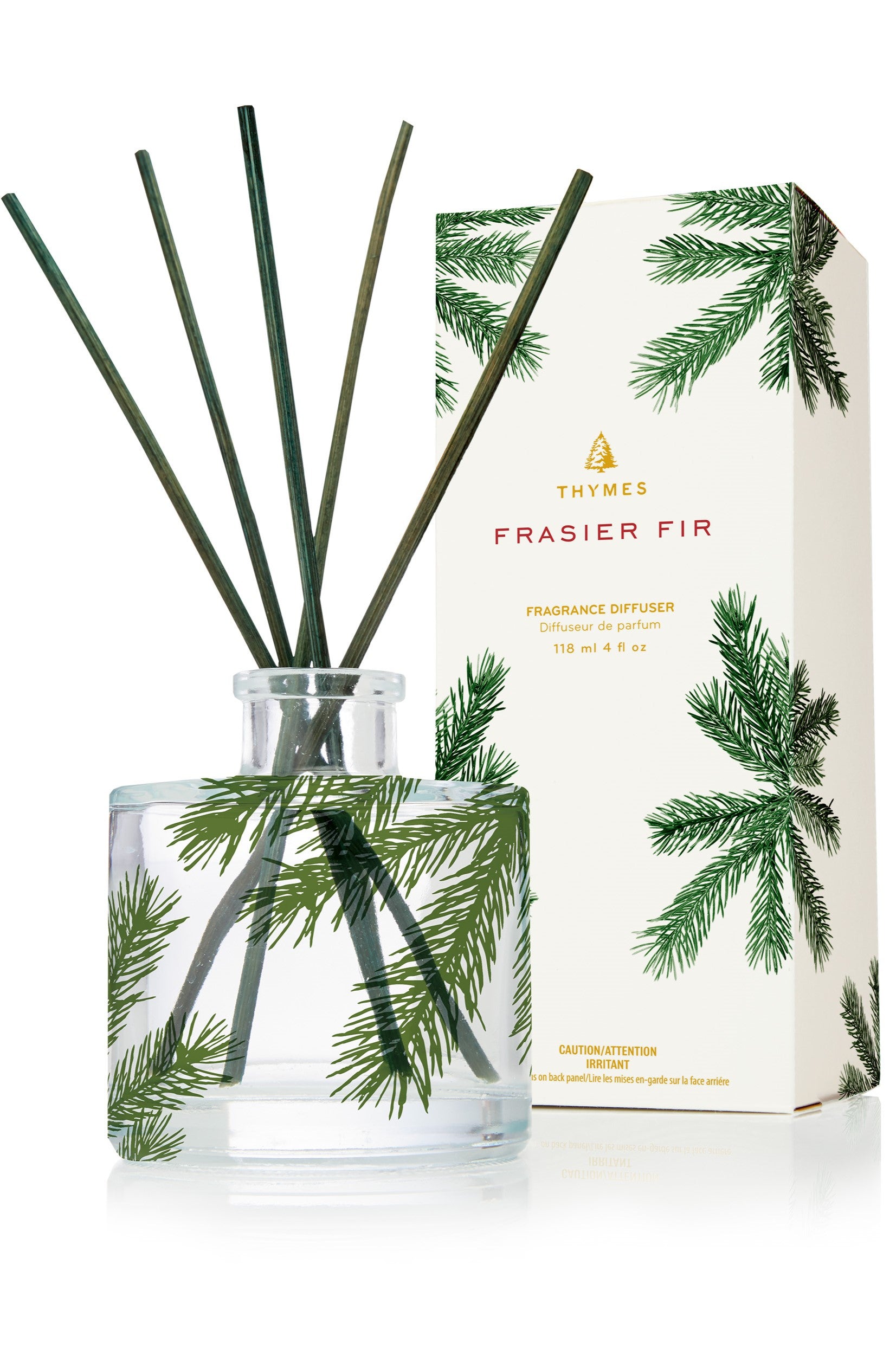 The Thymes Frasier Fir Petite Pine Needle Reed Diffuser in Green Multi features a pine design and reed sticks, filling your space with a mountain-fresh scent—an elegant, flameless way to bring the outdoors inside.