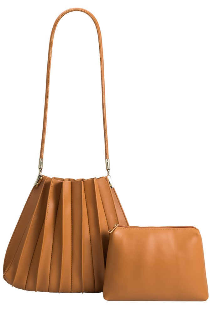 The Melie Bianco Carrie Tan features a pleated premium handbag with a long strap, shown beside a matching smooth zippered pouch. Both are available in leather or vegan leather.