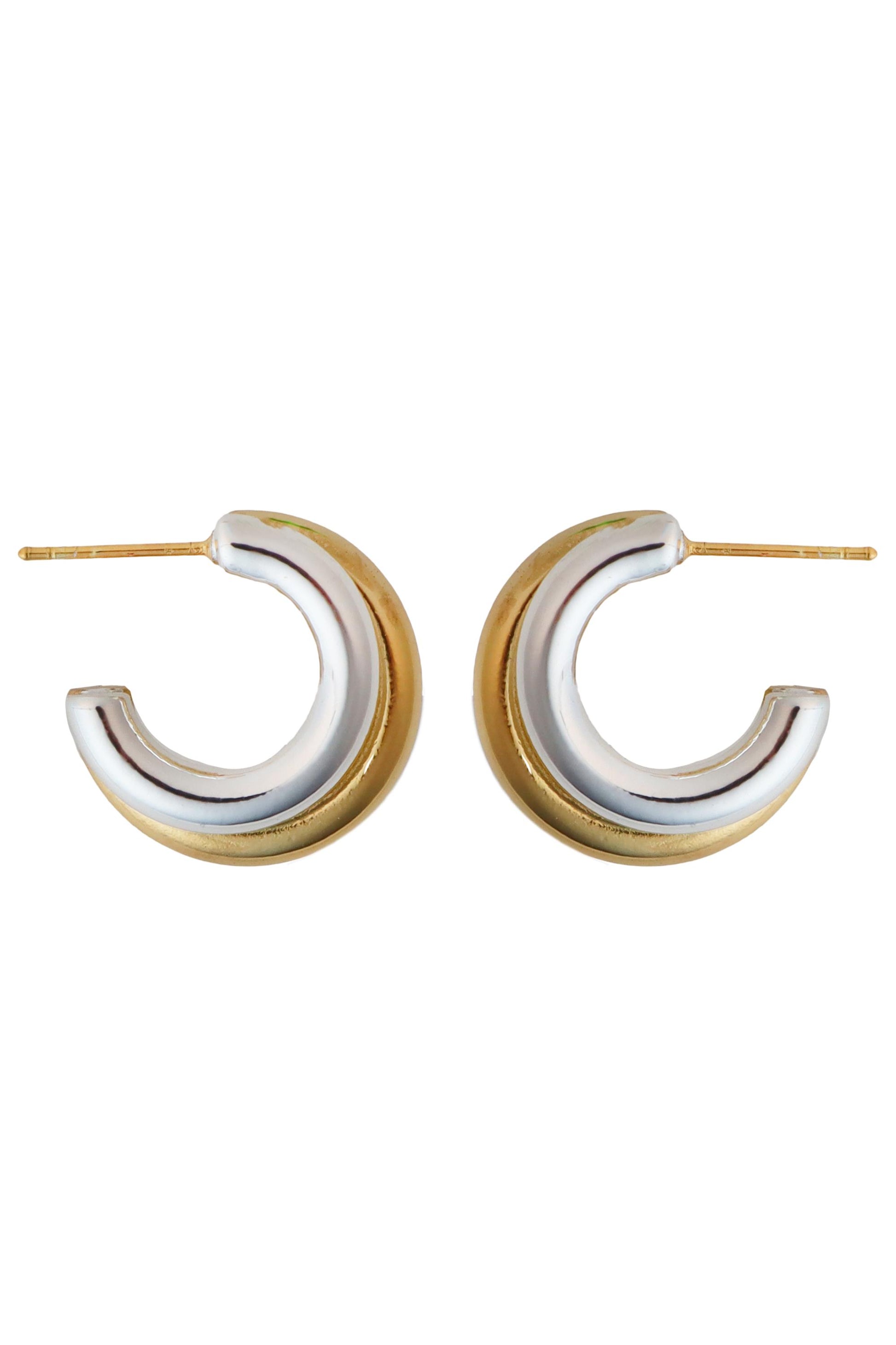 The South Moon Under Mix Two-Tone Classic Hoop Earrings are small, thick rhodium and gold-plated hoops with silver and gold tones, designed with posts for pierced ears.