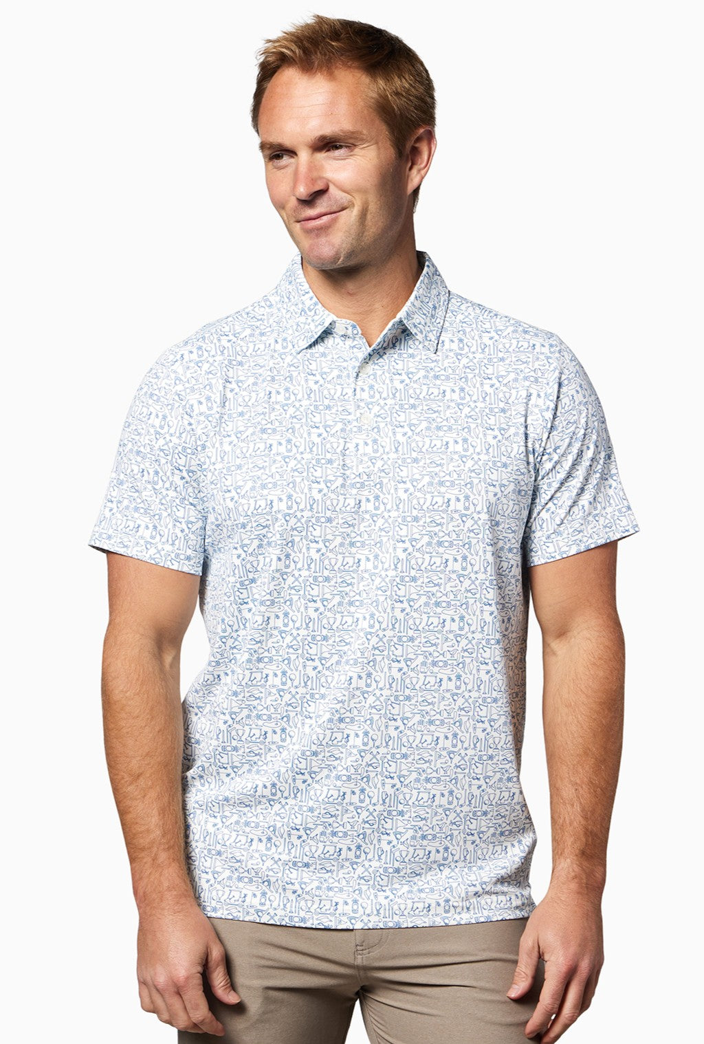 A man with short light brown hair smiles slightly while wearing the Clubhouse Polo Tequila Therapy by Toes on the Nose and beige pants, standing against a plain white background.