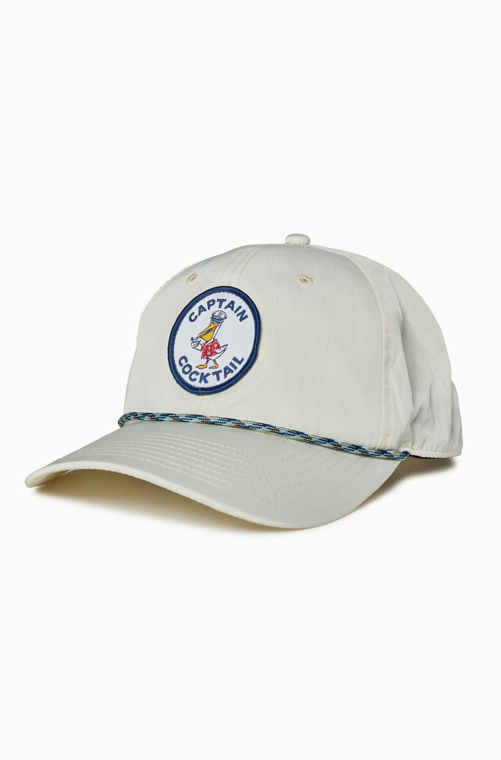 The Captain Cocktail Hat by Toes on the Nose is a natural 5-panel unstructured snapback featuring a blue and white Captain Cocktail patch with a cartoon, plus a decorative blue and white braided cord above the brim.
